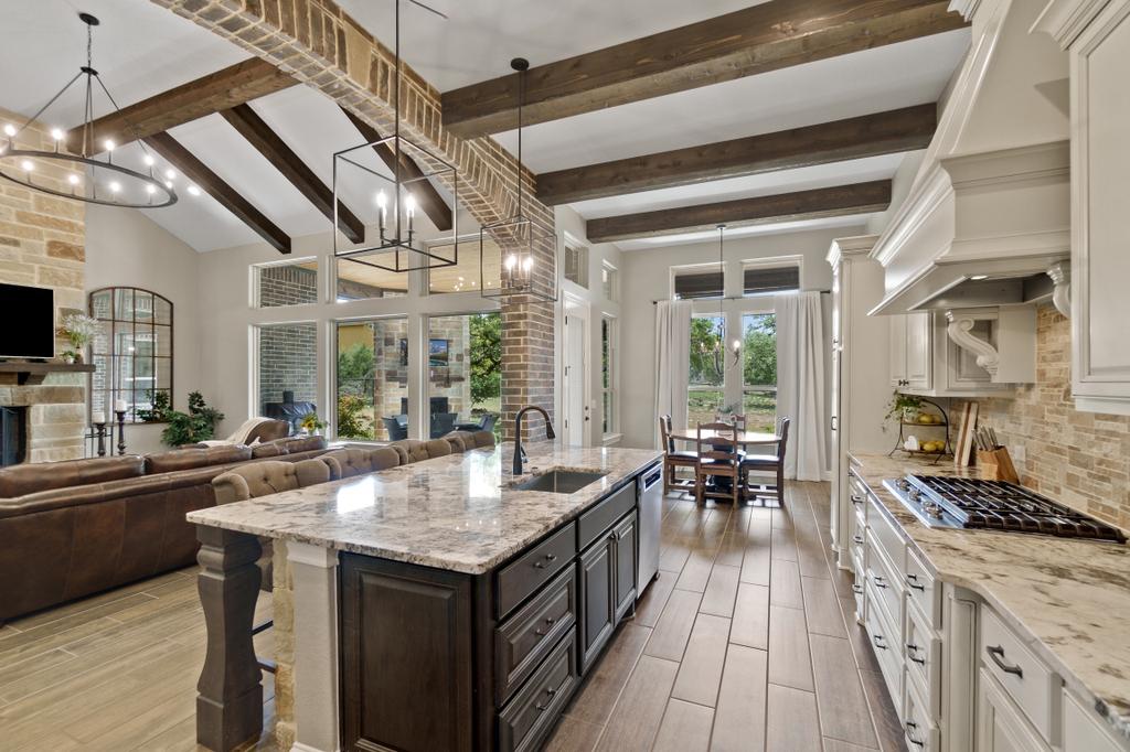 kitchen with brick and wood beams